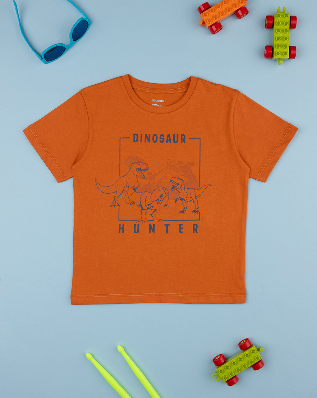 T-shirt bimbo arancione stampata dinosauri