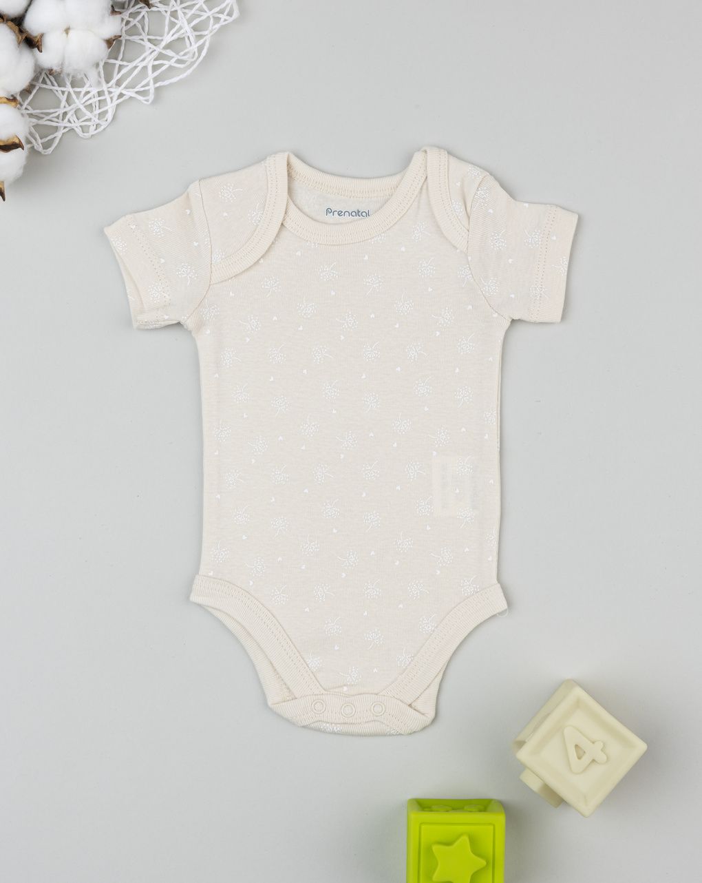 Body neonata beige con fiori allover