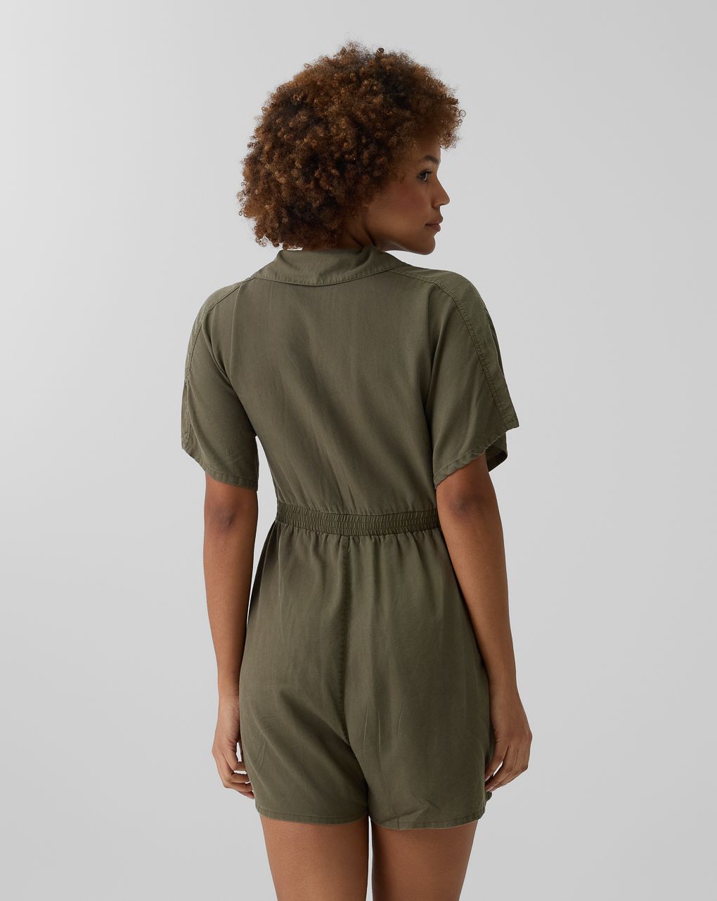 Tuta corta premaman verde con bottoni e tasche
