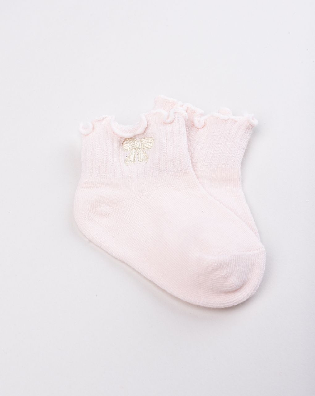 Calzini neonata rosa con bordo ondulato e fiocco