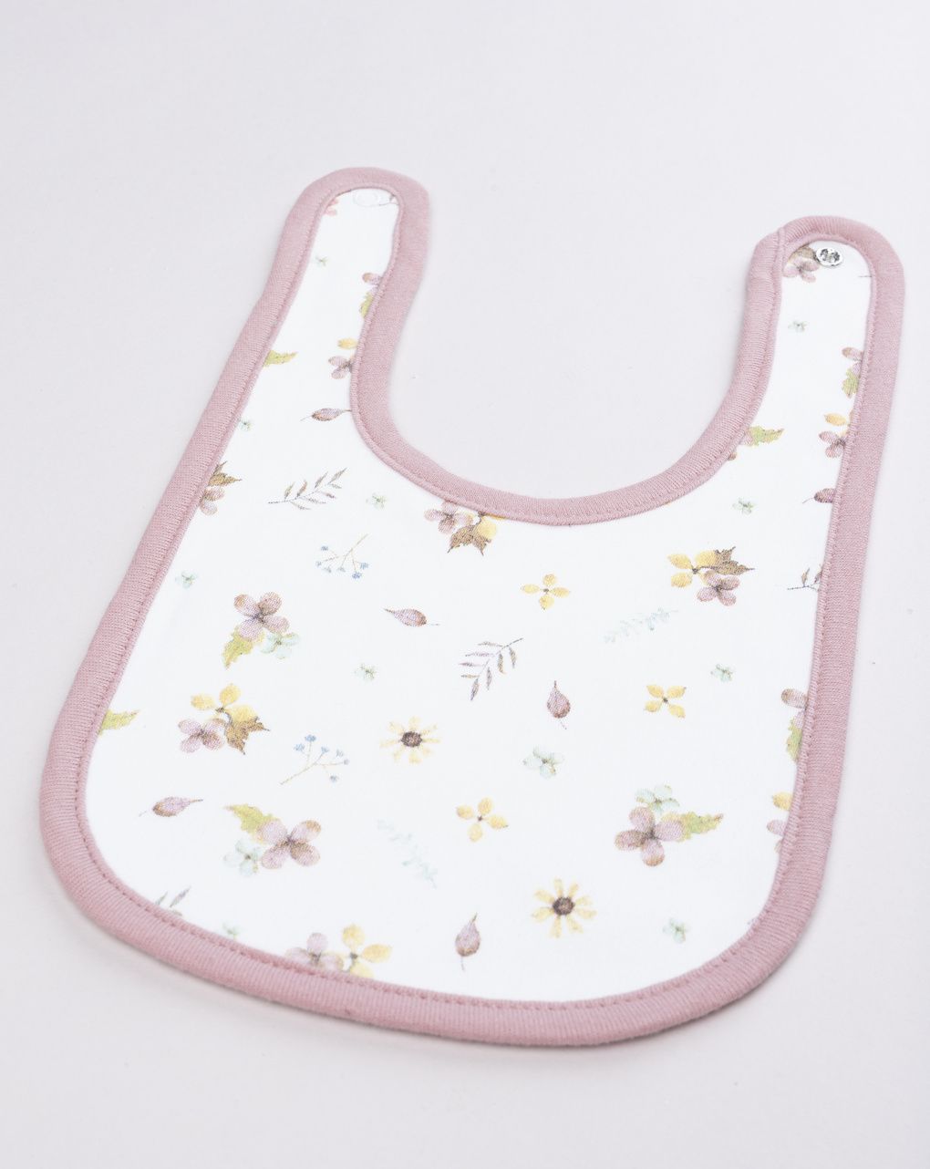 Bavaglino neonata con stampa fiori e bordo rosa
